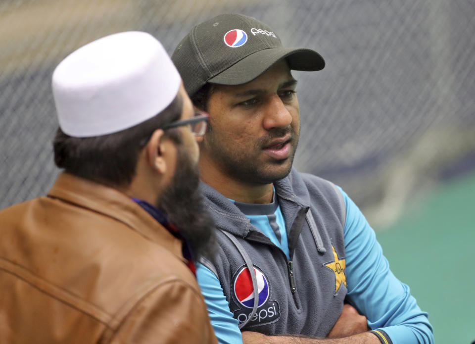 Pakistan cricket chief selector Inzamam-ul-Haq, left, listens to captain Sarfaraz Ahmed during a training session ahead of their Cricket World Cup match against India at Old Trafford in Manchester, England, Saturday, June 15, 2019. (AP Photo/Aijaz Rahi)