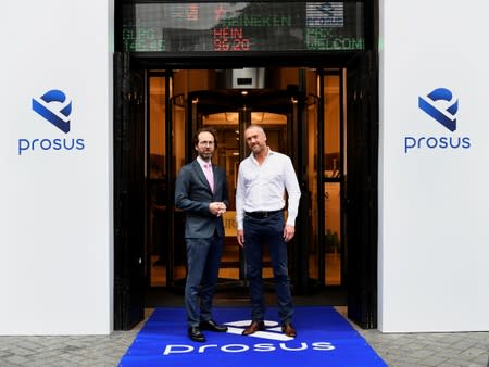 Maurice van Tilburg, CEO of Euronext Amsterdam and Bob van Dijk, CEO of Naspers and Prosus Group pose at Amsterdam's stock exchange building as Prosus begins trading on the Euronext stock exchange in Amsterdam