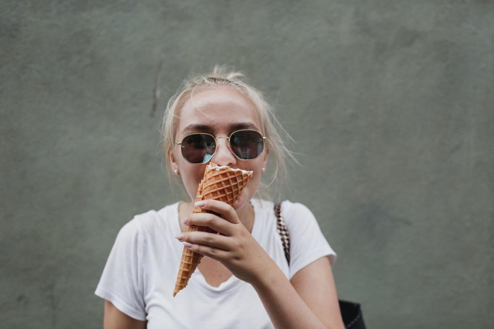 young woman eating ice cream cone