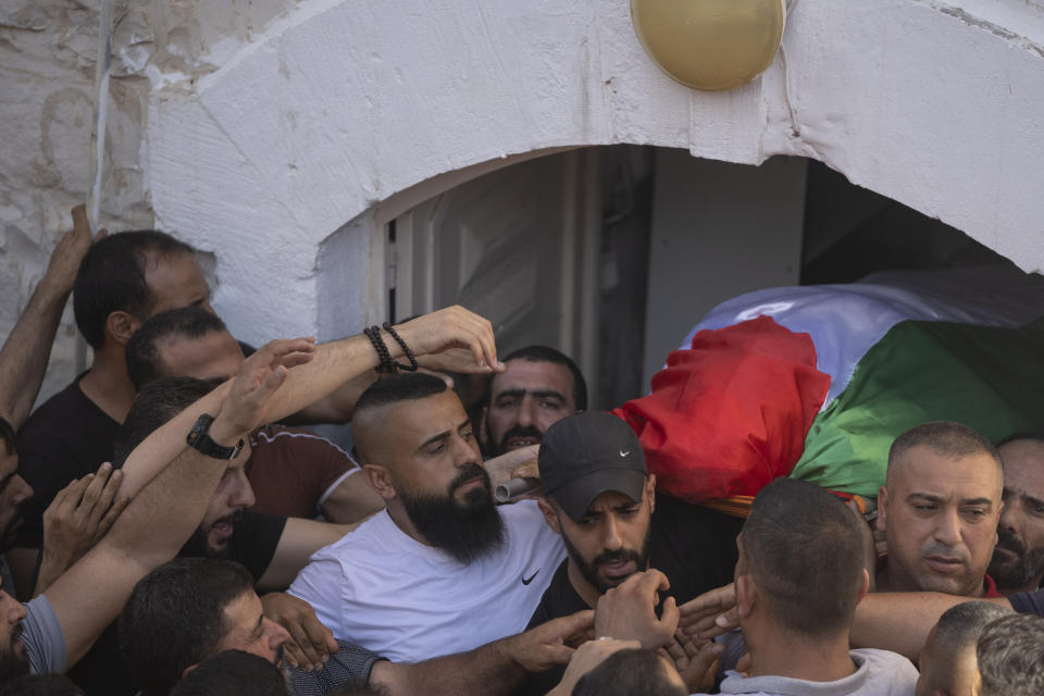 Mourners carry the body of Salah Sawafta, 58 during his funeral in the West Bank city of Tubas, Friday, Aug. 19, 2022. Israeli forces shot and killed Sawafta during an arrest raid in the occupied West Bank on Friday, according to his brother, who said he was walking home when a bullet struck him in the head as Israeli forces clashed with Palestinian youths. (AP Photo/Nasser Nasser)