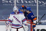 New York Rangers goaltender Igor Shesterkin looks down as New York Islanders Mathew Barzal (13) celebrates with teammates after a goal by Jordan Eberle during the third period of an NHL hockey game Tuesday, April 20, 2021, in Uniondale, N.Y. The Islanders won 6-1. (AP Photo/Frank Franklin II)