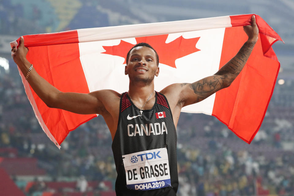 FILE - In this Oct. 1, 2019, file photo, Andre de Grasse, of Canada, celebrates after winning the silver medal in the men’s 200 meters at the World Athletics Championships in Doha, Qatar. When the American Track League opens its four-week-long series on Sunday, Jan. 24, 2021 de Grasse will be one of the athletes competing at the indoor setting at the University of Arkansas. (AP Photo/Hassan Ammar, File)