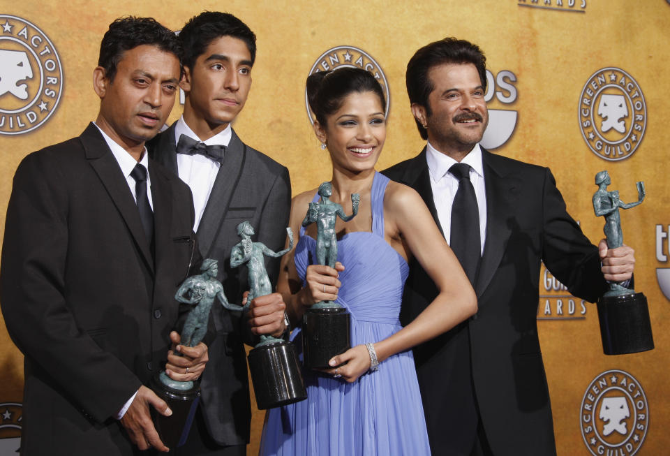 Members of the cast of "Slumdog Millionaire" pose backstage with the award for outstanding performance by a cast in a motion picture during the 15th Annual Screen Actors Guild Awards on Sunday, Jan. 25, 2009, in Los Angeles. From left are: Irrfan Khan, Dev Patel, Freida Pinto and Anil Kapoor. (AP Photo/Reed Saxon)