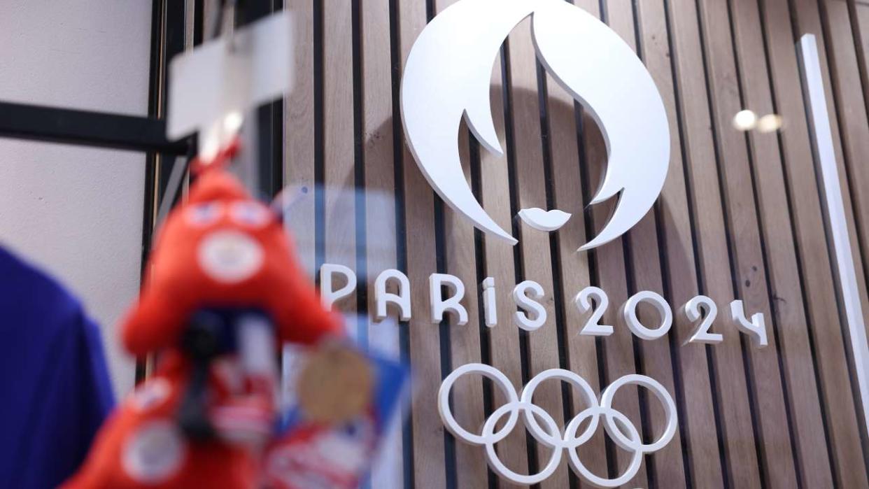 This photograph taken on November 15, 2022, in Paris, shows the Paris 2024 Olympic and Paralympic Games official logo, displayed in the official Paris 2024 shop in Les Halles shopping mall in central Paris. - The Olympic and Paralympic mascots are named 