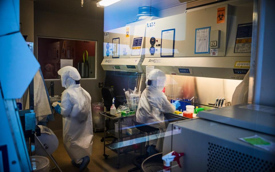 Technicians wearing full body protection suits work inside a biosafety level 3 Covid-19 research laboratory at the African Health Research Institute (AHRI) in Durban, South Africa, on Wednesday, Dec. 15, 2021 - Waldo Swiegers/Bloomberg