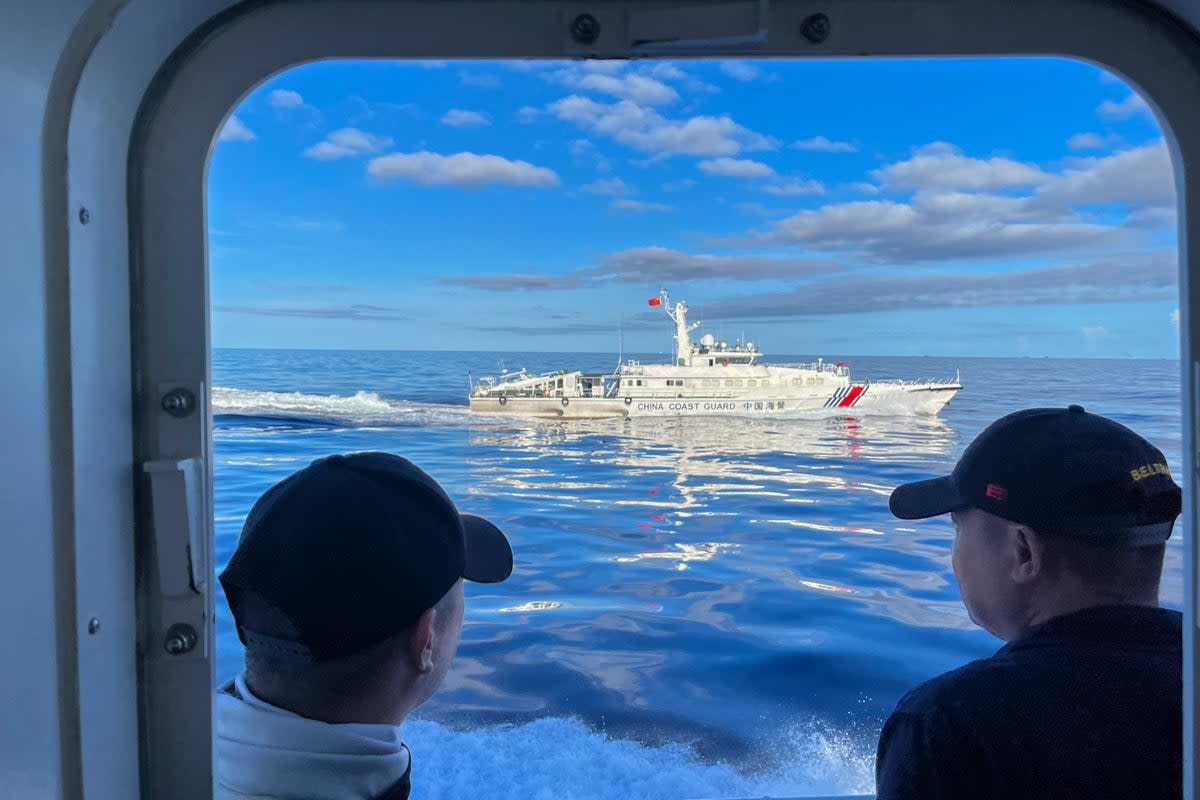 A Chinese coastguard vessel maneuvers beside the Philippine coast guard ship BRP Cabra as they approach Second Thomas Shoal  (AP)