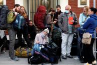 Stranded tourists from Germany wait for a shuttle bus to transport them to the airport in Kathmandu