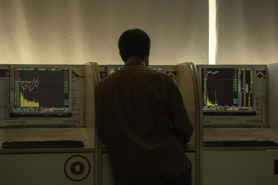 An investor monitors stock prices at a brokerage in Beijing on Thursday, Dec. 12, 2019. Asian shares are mixed after a wobbly day on Wall Street following the Federal Reserve announcement that it would leave interest rates unchanged. Japan's benchmark Nikkei 225, South Korea's Kospi and Hong Kong's Hang Seng rose in early Thursday trading. (AP Photo/Ng Han Guan)