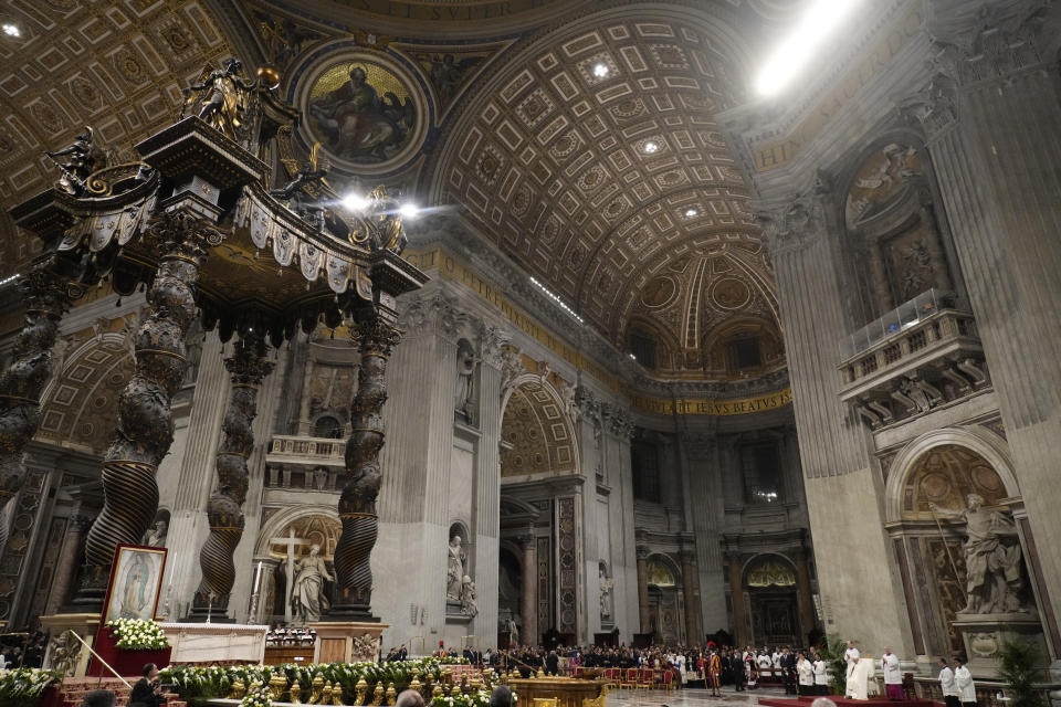 Pope Francis, right, presides over a mass in honor of our lady of Guadalupe in St. Peter's Basilica at The Vatican, Monday, Dec. 12, 2022. (AP Photo/Gregorio Borgia)