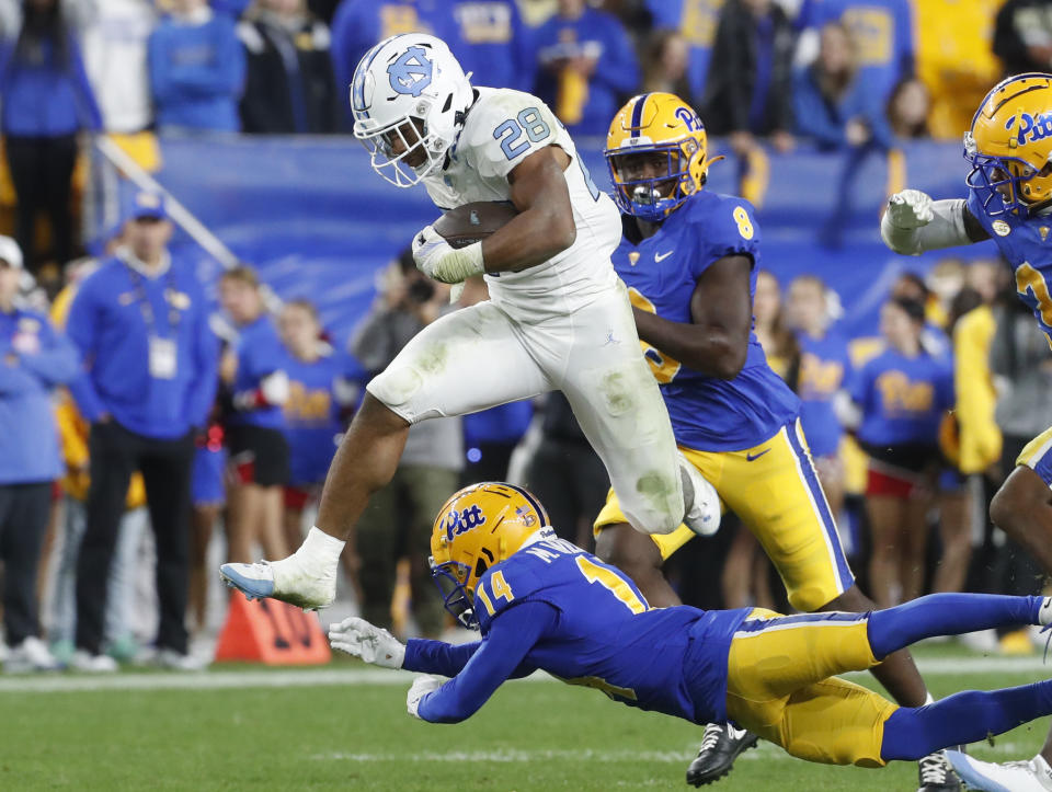 Sep 23, 2023; Pittsburgh, Pennsylvania, USA; North Carolina Tar Heels running back Omarion Hampton (28) leaps over a tackle attempt by /pit14d/ during the third quarter at Acrisure Stadium. The Tar Heels won 41-24. Mandatory Credit: Charles LeClaire-USA TODAY Sports