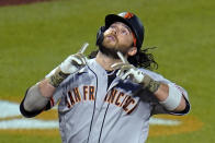 San Francisco Giants' Brandon Crawford celebrates as he crosses home plate on a solo home run off Pittsburgh Pirates relief pitcher Duane Underwood Jr. during the eighth inning of a baseball game in Pittsburgh, Friday, May 14, 2021. (AP Photo/Gene J. Puskar)