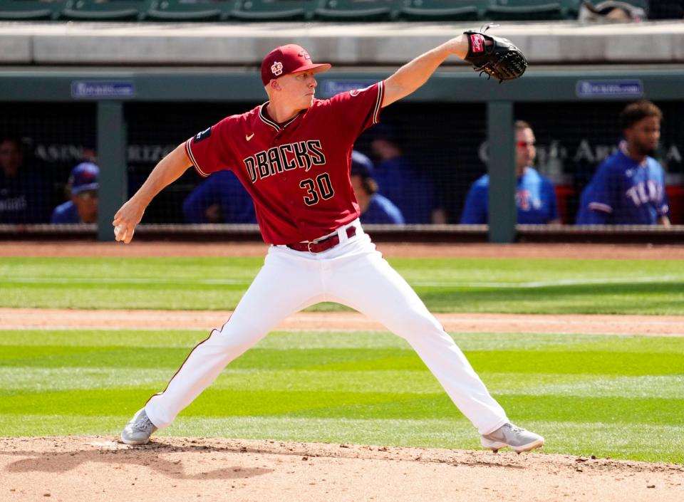 Arizona Diamondbacks relief pitcher Scott McGough (30) throws to the Texas Rangers in the sixth inning during a spring training game at Salt River Fields in Scottsdale on March 8, 2023.