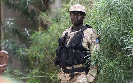 A South Sudanese policeman stands outside a compound following renewed fighting in South Sudan's capital Juba, July 10, 2016. REUTERS/Stringer