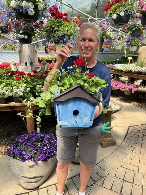Julie Freebern of Willo'Dell Nursery introduces a birdhouse hanging planter to Art of Gardening Club members.