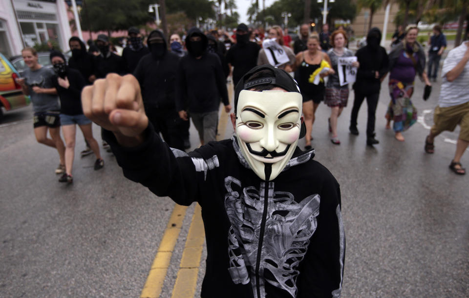 Demonstrators march in downtown St. Petersburg, Fla., Sunday, Aug. 26, 2012. The protestors were demonstrating outside Tropicana Field where a welcoming event is taking place for the delegates of the Republican National Convention (AP Photo/Dave Martin)