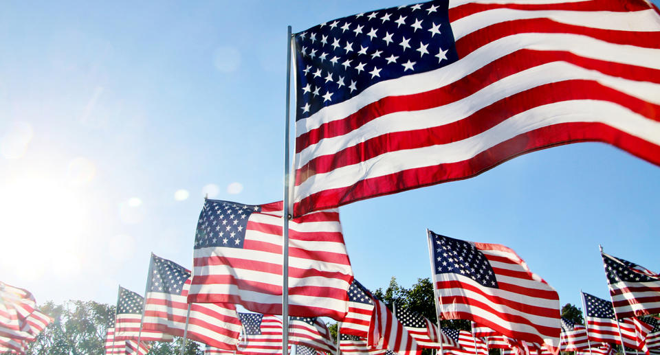 A stock image of United States of America flags blow in the wind. The young boy was commended for his kind act by Texas police officers.