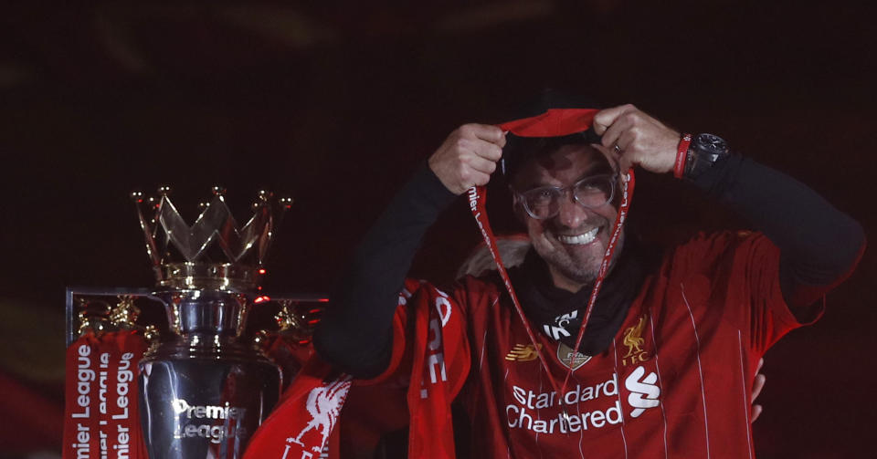 Liverpool's manager Jurgen Klopp puts on his winner medal prior to his team lifting the English Premier League trophy following the English Premier League soccer match between Liverpool and Chelsea at Anfield Stadium in Liverpool, England, Wednesday, July 22, 2020. Liverpool are champions of the EPL for the season 2019-2020. The trophy is presented at the teams last home game of the season. Liverpool won the match against Chelsea 5-3. (Phil Noble/Pool via AP)