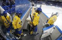 Team Sweden is led to the ice by Goalkeeper Valentina Wallner before the first period of the 2014 Winter Olympics women's semifinal ice hockey game against USA at Shayba Arena Monday, Feb. 17, 2014, in Sochi, Russia. (AP Photo/Petr David Josek)