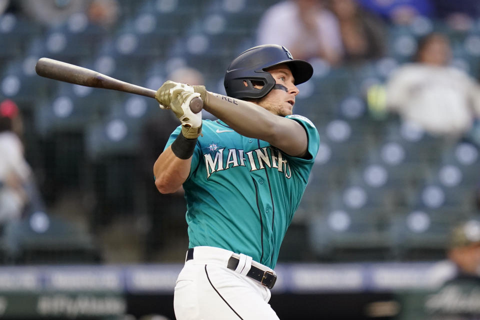 Seattle Mariners' Jarred Kelenic watches his two-run home run against the Cleveland Indians in the third inning of a baseball game Friday, May 14, 2021, in Seattle. (AP Photo/Elaine Thompson)