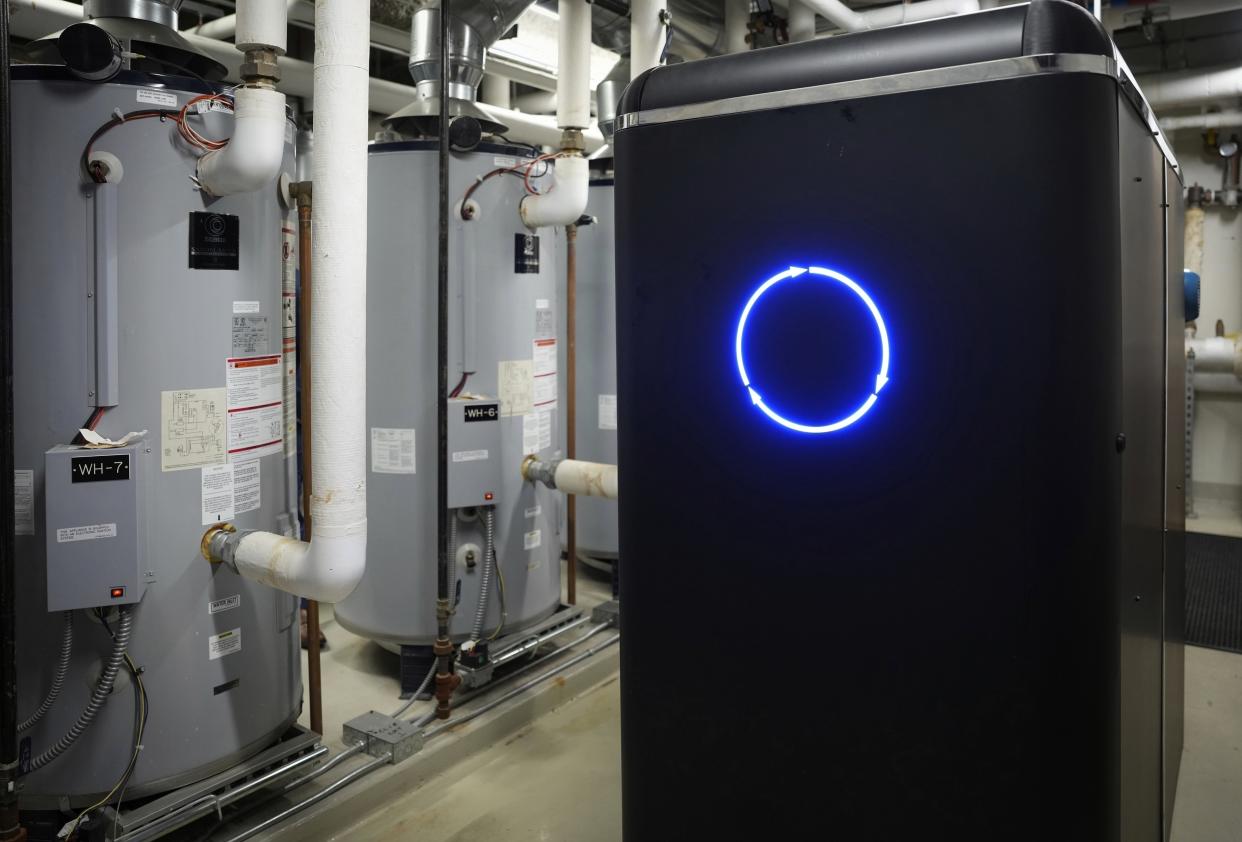 A CarbinX unit, which is about the size of two refrigerators, has been installed and is operating at a Radisson Blu in Bloomington, Minn., on March 21, 2023. The system, which captures carbon dioxide, is eventually used to make soap. (Shari L. Gross/Star Tribune via AP)