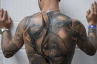 <p>A visitor shows his tattooed back at the London Tattoo convention at Tobacco Dock on Sept. 23, 2017 in London, England. Over 400 tattoo artists are attending the three day event in East London to showcase their artistry and for visitors to see and have tattoos done for themselves. (Photo: James D. Morgan/Getty Images) </p>