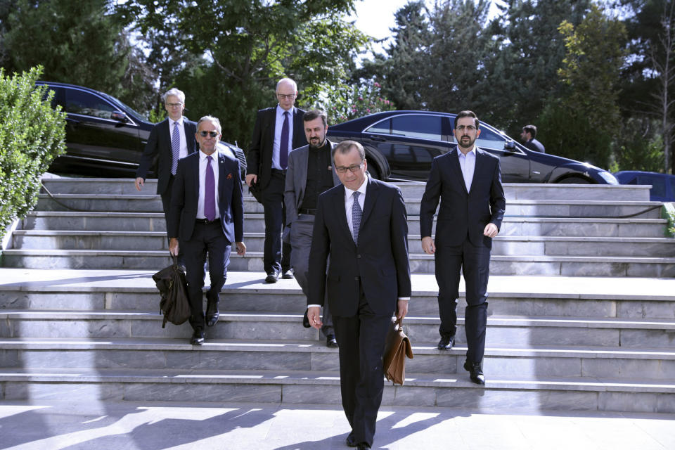 In this photo released by the Atomic Energy Organization of Iran, acting chief of the International Atomic Energy Agency, IAEA, Cornel Feruta, center, arrives for a meeting with the head of Iran's nuclear chief Ali Akbar Salehi, in Tehran, Iran, Sunday, Sept. 8, 2019. After the meeting Salehi said the European Union has failed to honor its commitments under Tehran's nuclear deal with world powers, following the U.S. withdrawal from the 2015 accord over a year ago. (Atomic Energy Organization of Iran via AP)