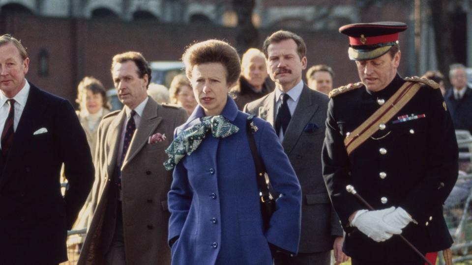 Princess Anne walking with Andrew Parker Bowles in a ceremonial uniform