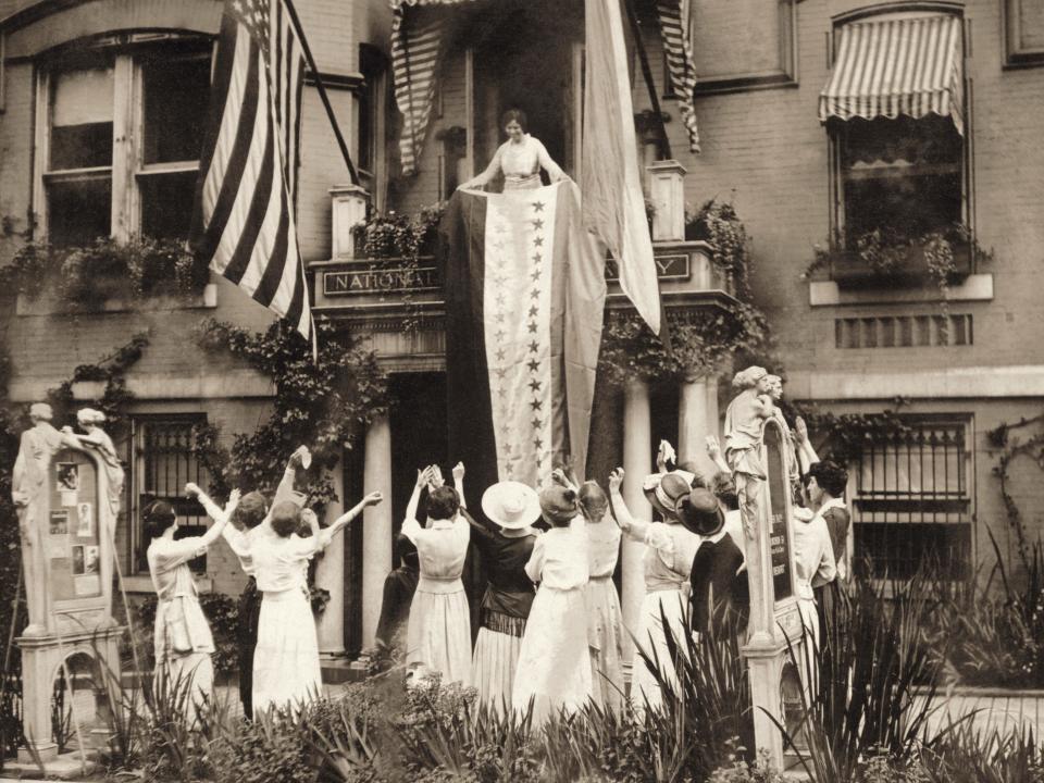 Women stand and cheer at the National Women's Party headquarters in 1920.