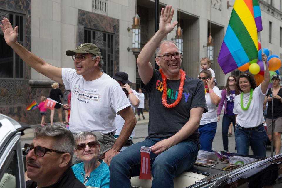 Gay marriage plaintiff Jim Obergefell, center, waves during the Cincinnati Pride parade, Saturday, June 27, 2015, in Cincinnati.
