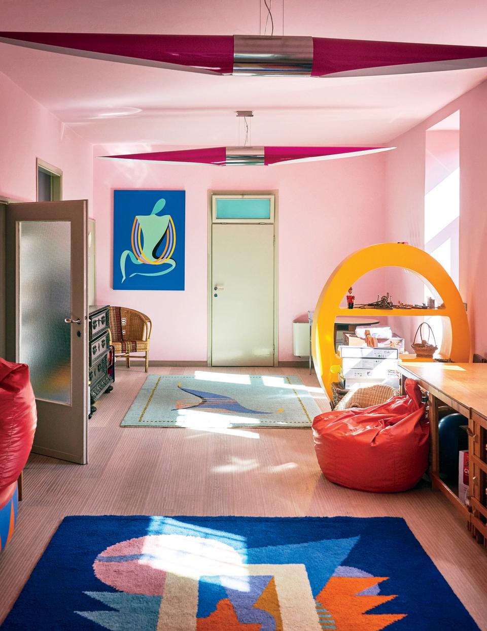 A colorful playroom in Mendini's vacation home features a painting, rug, and bookcase all by the designer.