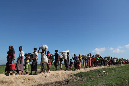 Rohingya refugees walk towards a refugee camp after crossing the border in Anjuman Para near Cox's Bazar, Bangladesh, November 19, 2017. REUTERS/Mohammad Ponir Hossain