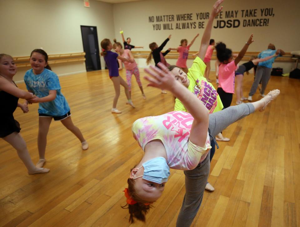 Emmaile Frazier, 9, is dipped by Adeline Soloman, 10, as they and the rest of the intermediate ballet class rehearse for their ballet production of "Peter Pan" at the Judy Dollenmayer Studio of Dance in Gahanna on March 24.