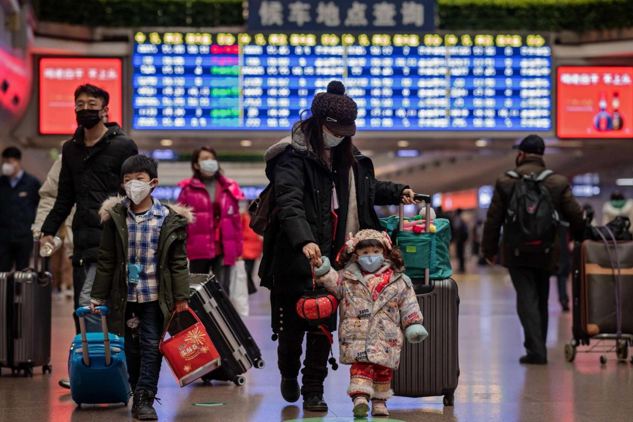 A family travels back home for the Lunar New Year holidays: AFP via Getty Images