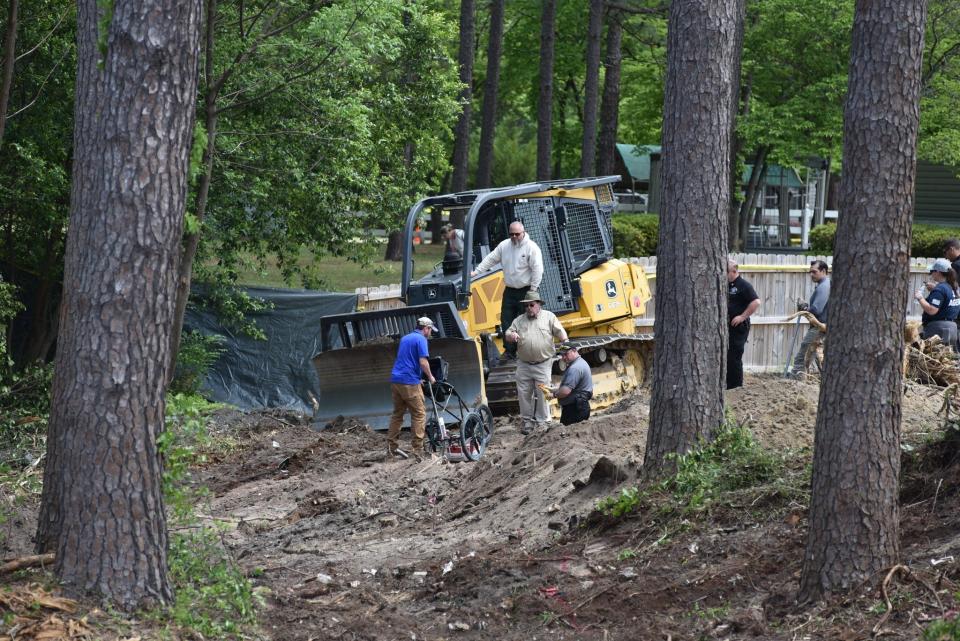 Dr. Billy Oliver and John Deloatch pinpoint an area to be excavated by members of the N.C. Forest Service and Cumberland Sheriff's Office.