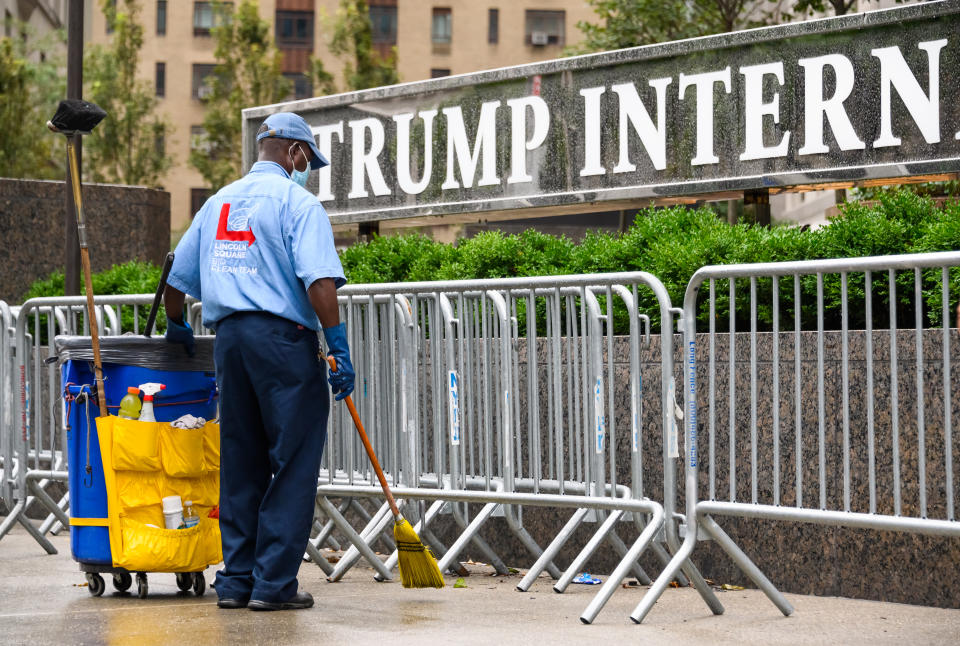 NEW YORK, NEW YORK - AUGUST 16: A sanitation worker cleans outside Trump International Hotel & Tower New York as the city continues Phase 4 of re-opening following restrictions imposed to slow the spread of coronavirus on August 16, 2020 in New York City. The fourth phase allows outdoor arts and entertainment, sporting events without fans and media production. (Photo by Noam Galai/Getty Images)