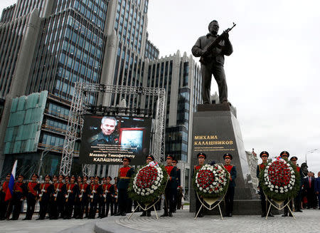 Guards of honour stand next to a monument to Mikhail Kalashnikov, the Russian designer of the AK-47 assault rifle, during its opening ceremony in Moscow, Russia September 19, 2017. REUTERS/Sergei Karpukhin TPX IMAGES OF THE DAY