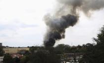 Smoke rises over Westgate Shopping center after an explosion in Nairobi, September 23, 2013. Powerful explosions sent thick smoke billowing from the Nairobi mall where militants from Somalia's al Qaeda-linked al Shabaab group threatened to kill hostages on the third day of a raid in which at least 59 have already died. (REUTERS/Goran Tomasevic)