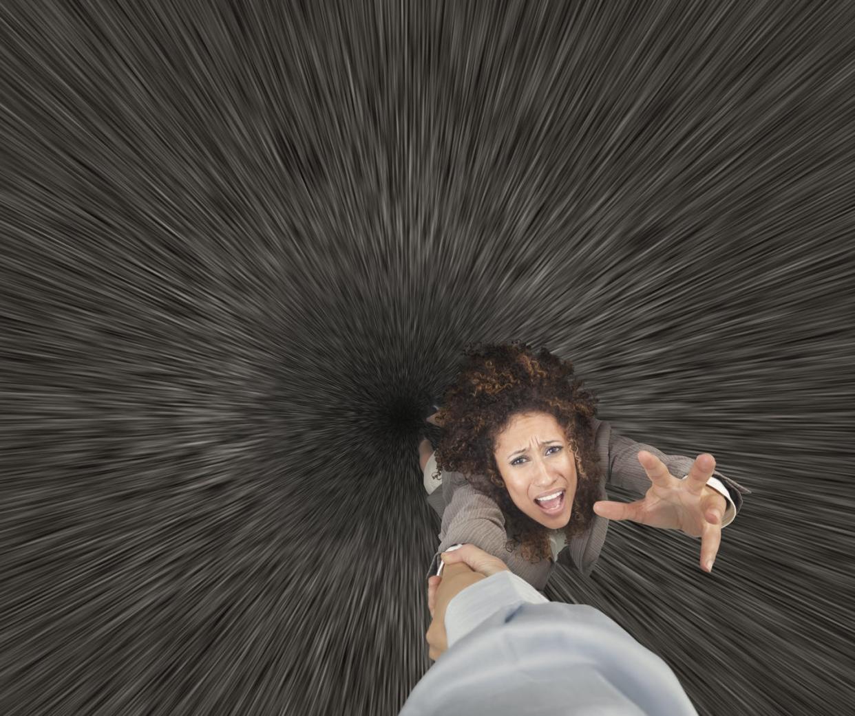 <span class="caption">Falling into a black hole is easily the worst way to die.</span> <span class="attribution"><a class="link " href="https://www.gettyimages.com/detail/photo/mixed-race-businesswoman-clinging-to-colleagues-royalty-free-image/476804893?adppopup=true" rel="nofollow noopener" target="_blank" data-ylk="slk:John M Lund Photography Inc/Getty Images;elm:context_link;itc:0;sec:content-canvas">John M Lund Photography Inc/Getty Images</a></span>