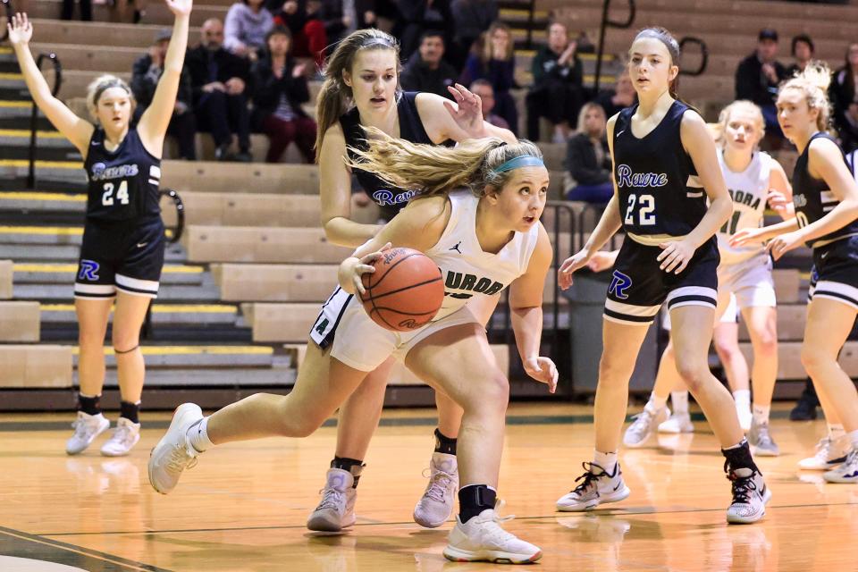 Aurora junior Grace Barbour drives to put in the game-winning basket on a reverse layup during Wednesday night’s game against Revere at Aurora High School.