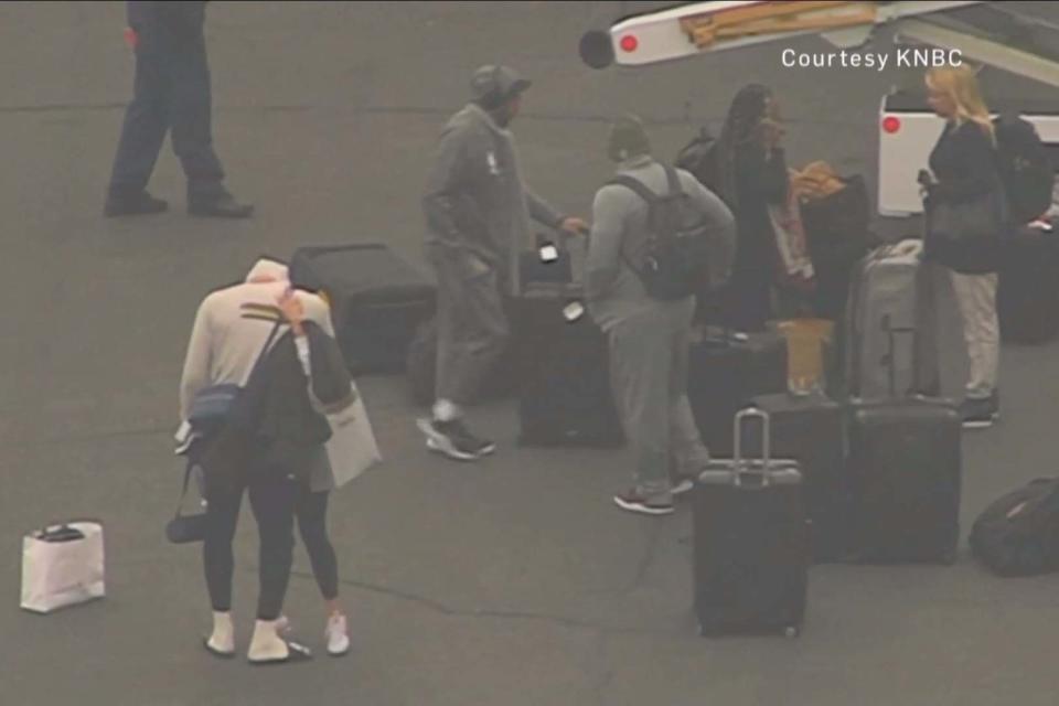 LeBron James seen in an embrace after leaving the Los Angeles Lakers' team plane on Sunday, shortly after Kobe Bryant's tragic death was first reported (KNBC)