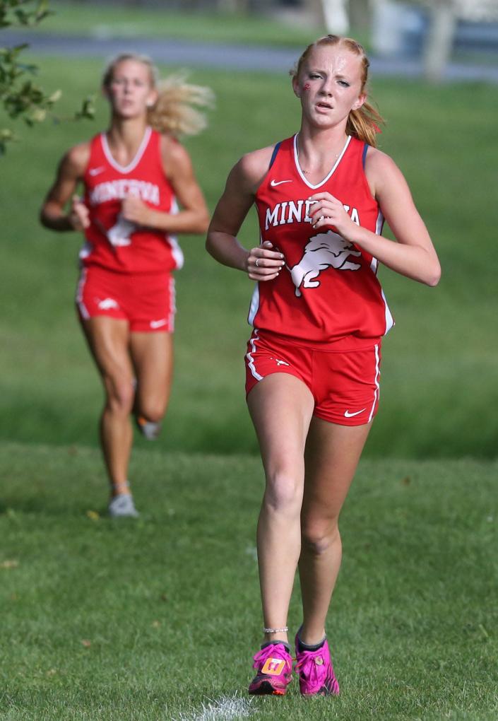 Hera Hoffee, front, and Jenna Cassidy, both of Minerva, finished second and third in the girls large school race at the East Canton Cross Country Invitational on Wednesday, Sept. 1, 2021.