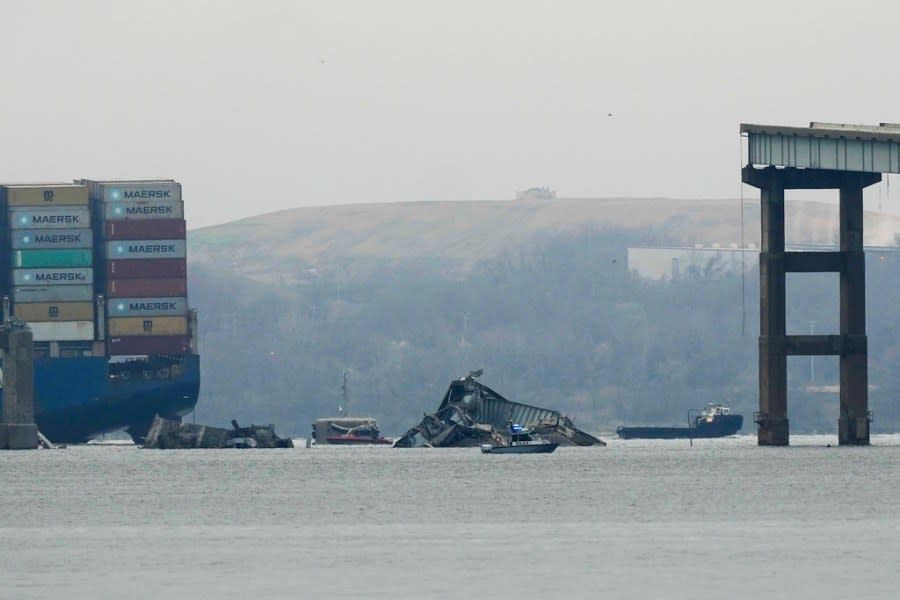 A container ship rests against wreckage of the Francis Scott Key Bridge on Wednesday, March 27, 2024, in Baltimore, Md. Recovery efforts resumed Wednesday for the construction workers who are presumed dead after the cargo ship hit a pillar of the bridge, causing the structure to collapse. (AP Photo/Matt Rourke)