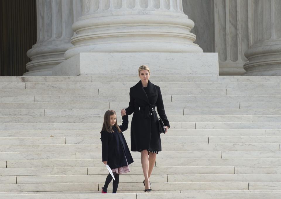 Ivanka Trump wearing a black coat of her own design with her daughter Arabella Kushner on the steps of the Supreme Court in Washington, D.C.