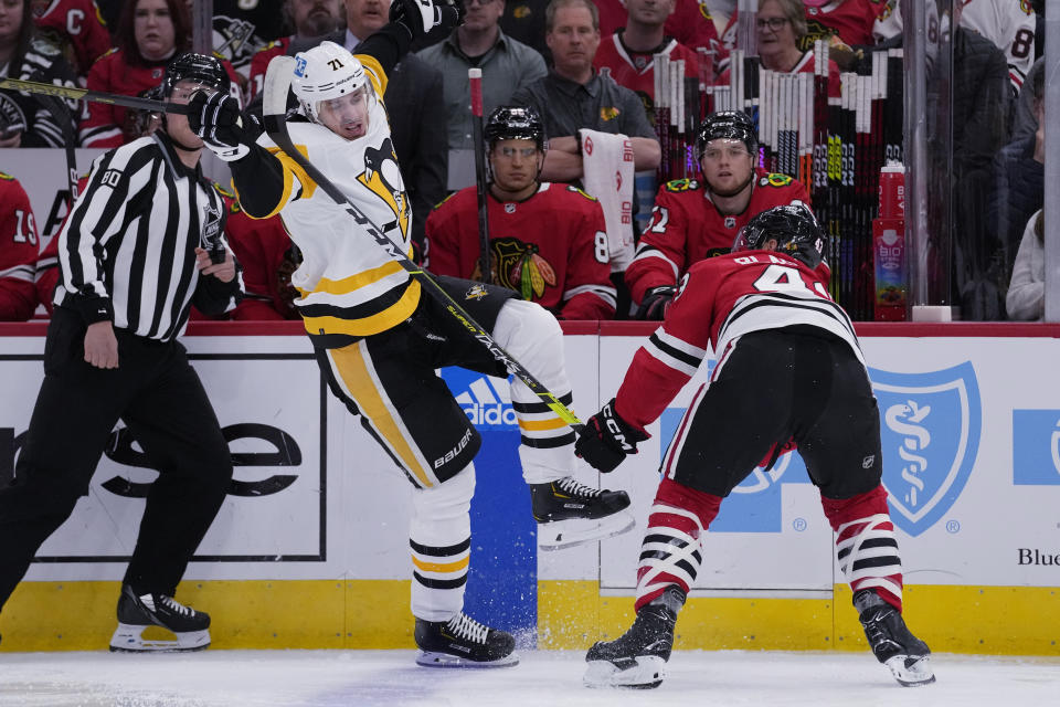 Pittsburgh Penguins center Evgeni Malkin, left, is checked by Chicago Blackhawks center Colin Blackwell during the first period of an NHL hockey game in Chicago, Sunday, Nov. 20, 2022. (AP Photo/Nam Y. Huh)