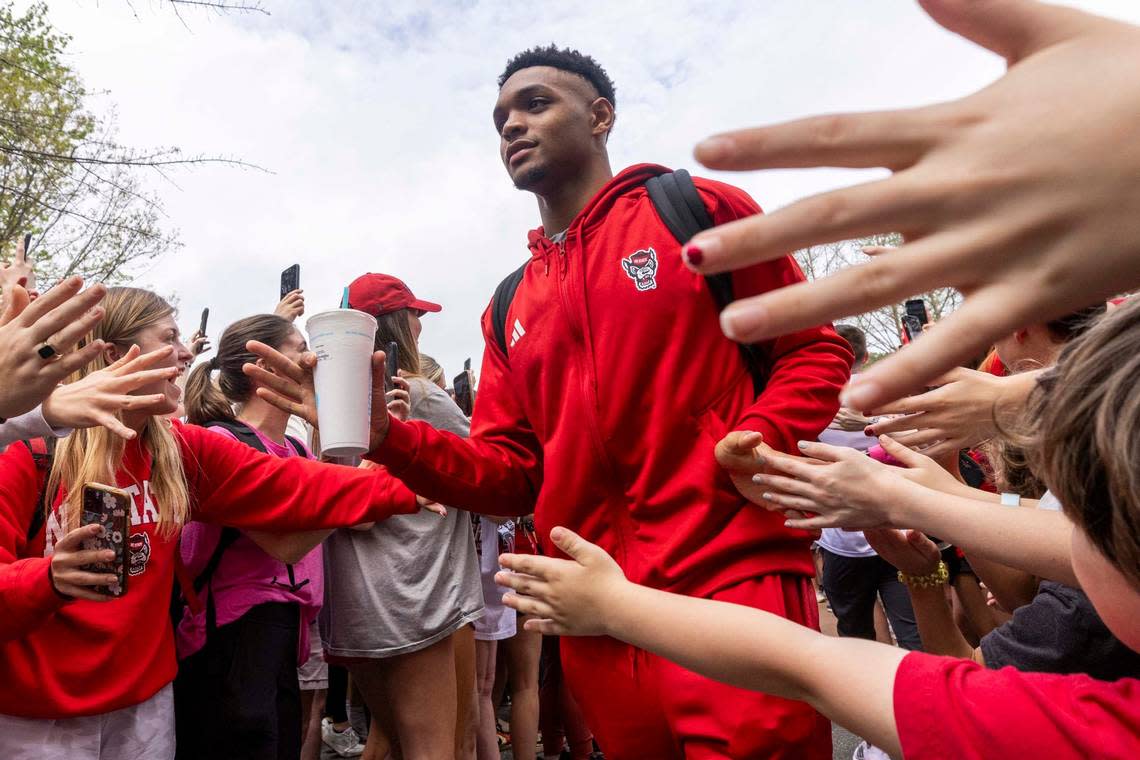 NC.State’s Casey Morsell is greeted by fans as the men’s basketball team departs on a bus Wednesday, April 3, 2024. NC State’s men’s basketball team is headed to the Final Four for the first time since 1983.