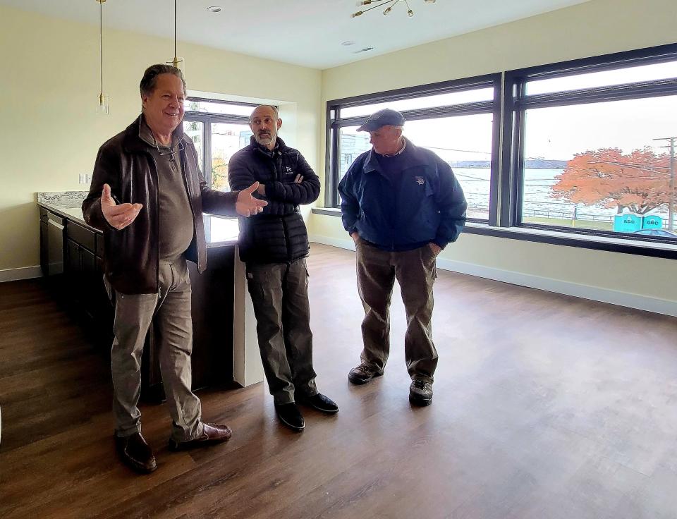 Developer Tom Vertin talks with others while touring Marine City Manor on Monday, Nov. 20, 2023. The development features six condos and three retail spaces.