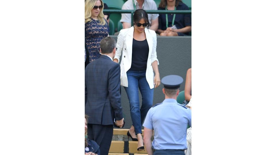 Meghan markle walking down stairs in jeans