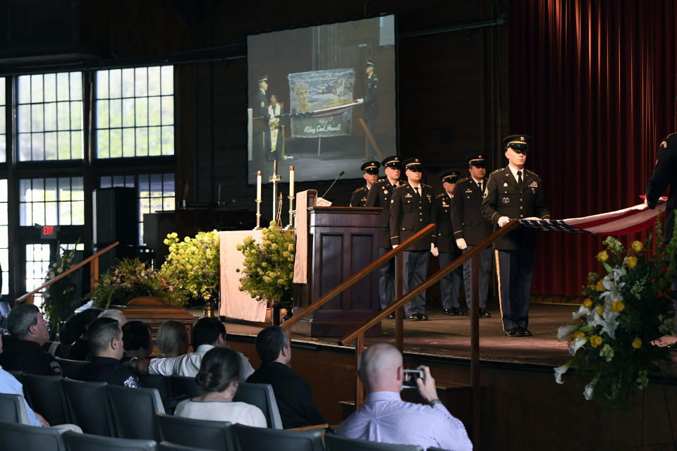 A military honor guard folds a flag for Riley Howell during his memorial service for Riley Howell in Lake Junaluska, N.C., Sunday, May 5, 2019. Family, hundreds of friends and a military honor guard on Sunday remembered Howell, a North Carolina college student credited with saving classmates by rushing a gunman firing inside their lecture hall. (AP Photo/Kathy Kmonicek)