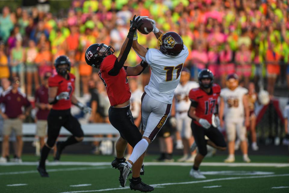 Harrisburg’s Cale Morton (11) catches the ball from Brandon Valley’s Ryland Carroll (23) at Brandon Valley Football Field in Brandon, South Dakota on Saturday, Sept. 2, 2023.