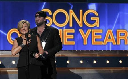 Country singer Lee Brice (R) and songwriter Connie Harrington accept the award for song of the year for "I Drive Your Truck" at the 49th Annual Academy of Country Music Awards in Las Vegas, Nevada April 6, 2014. REUTERS/Robert Galbraith